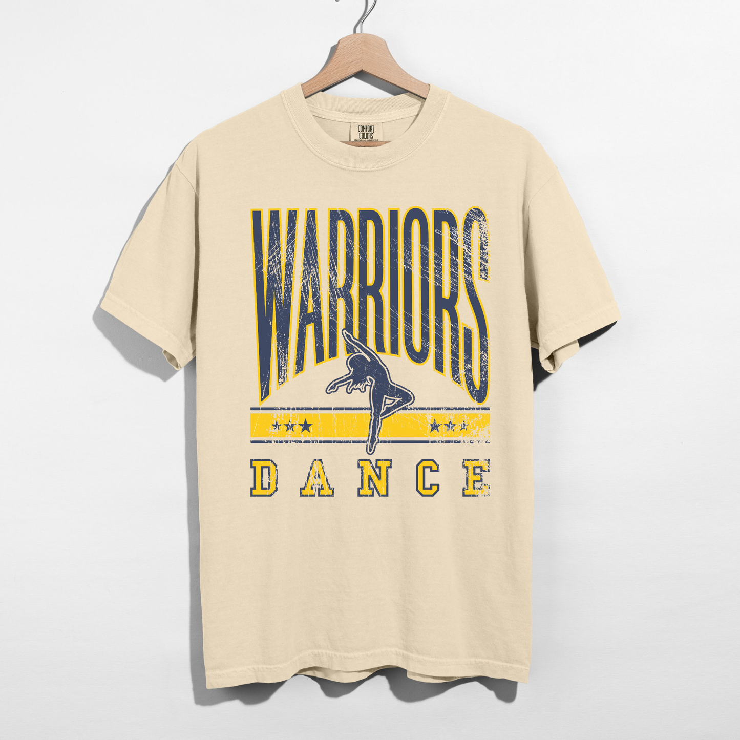 Ivory Warriors Dance unisex graphic t shirt with collegiate lettering displayed on hanger