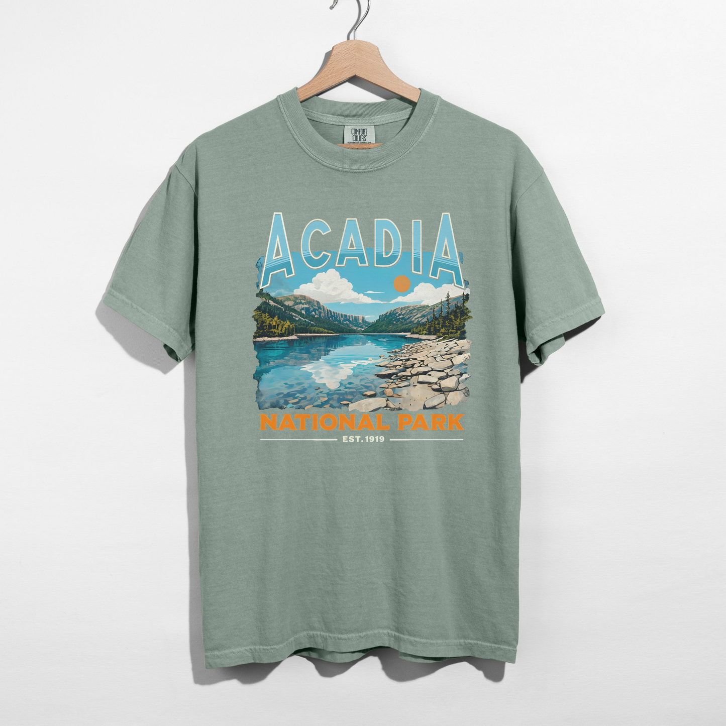 Bay green Acadia National Park scenic graphic t-shirt with mountain lake design and National Park est. 1919 detail.