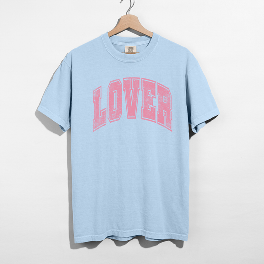 Light blue Comfort Colors Lover graphic t-shirt flat lay on hanger