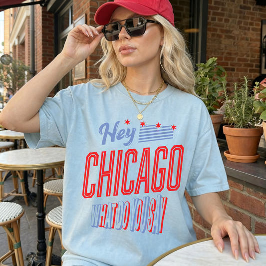 Woman wearing chambray blue Chicago city pride t-shirt styled with sunglasses and gold jewelry