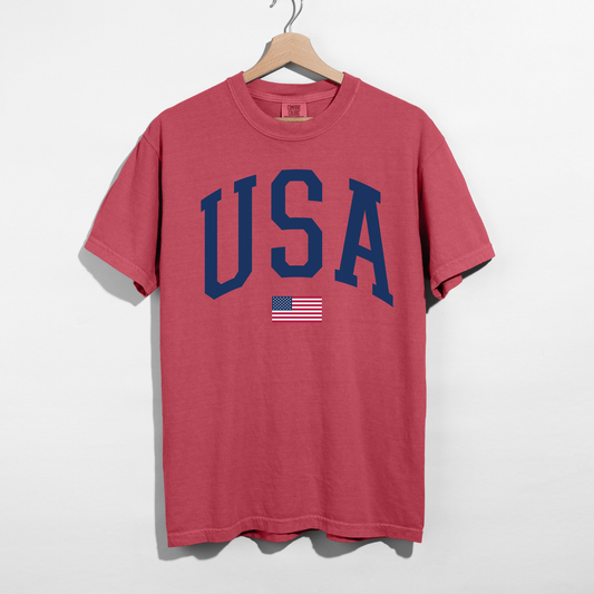 Crimson Red t-shirt with 'USA' and American flag on a hanger against a white background