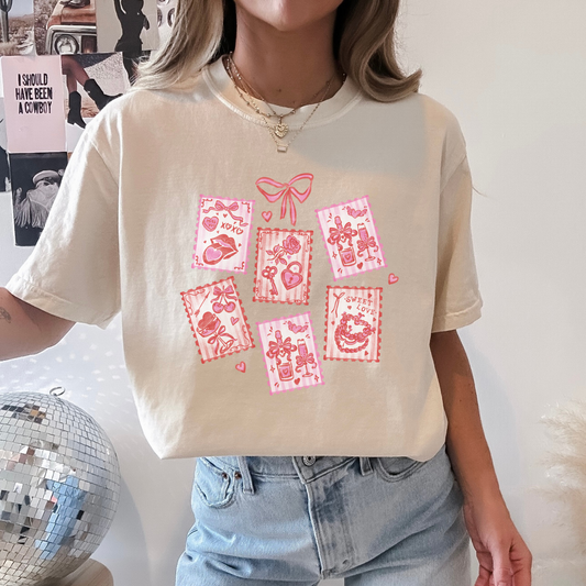 Woman wearing ivory Valentine stamps t-shirt with pink hand-drawn graphics.