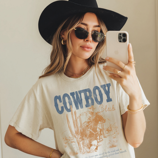Western cowboy club graphic tee worn by model styled with hat and sunglasses
