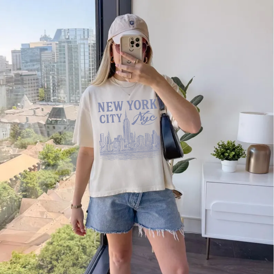 Woman wearing New York City graphic tee with vintage NYC skyline design