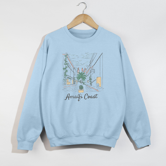 Light blue Amalfi Coast crewneck sweatshirt on wooden hanger against white wall.