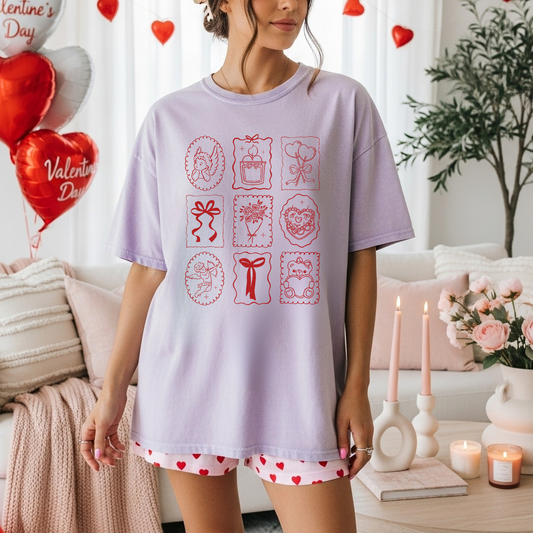 Woman wearing orchid Valentine stamp icons tee with heart shorts in Valentine decor setting.