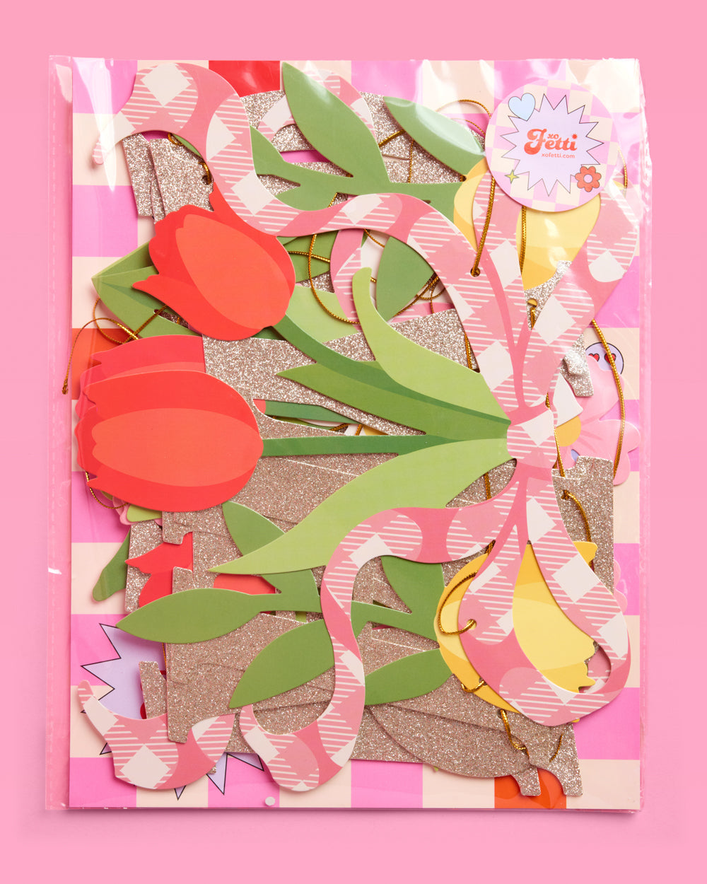 Decorative card with floral cutouts on a pink background