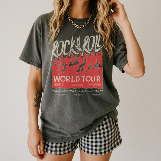 Person wearing a gray t-shirt with 'Rock & Roll World Tour' design and checkered shorts.