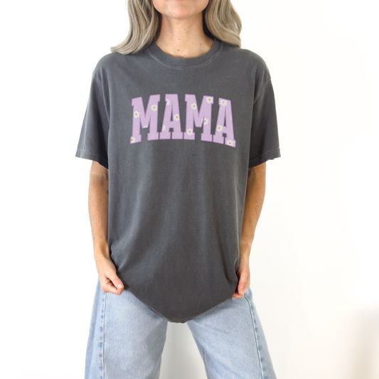 Woman wearing a dark gray Comfort Colors mama graphic t-shirt with purple floral lettering, classic neutral mom tee