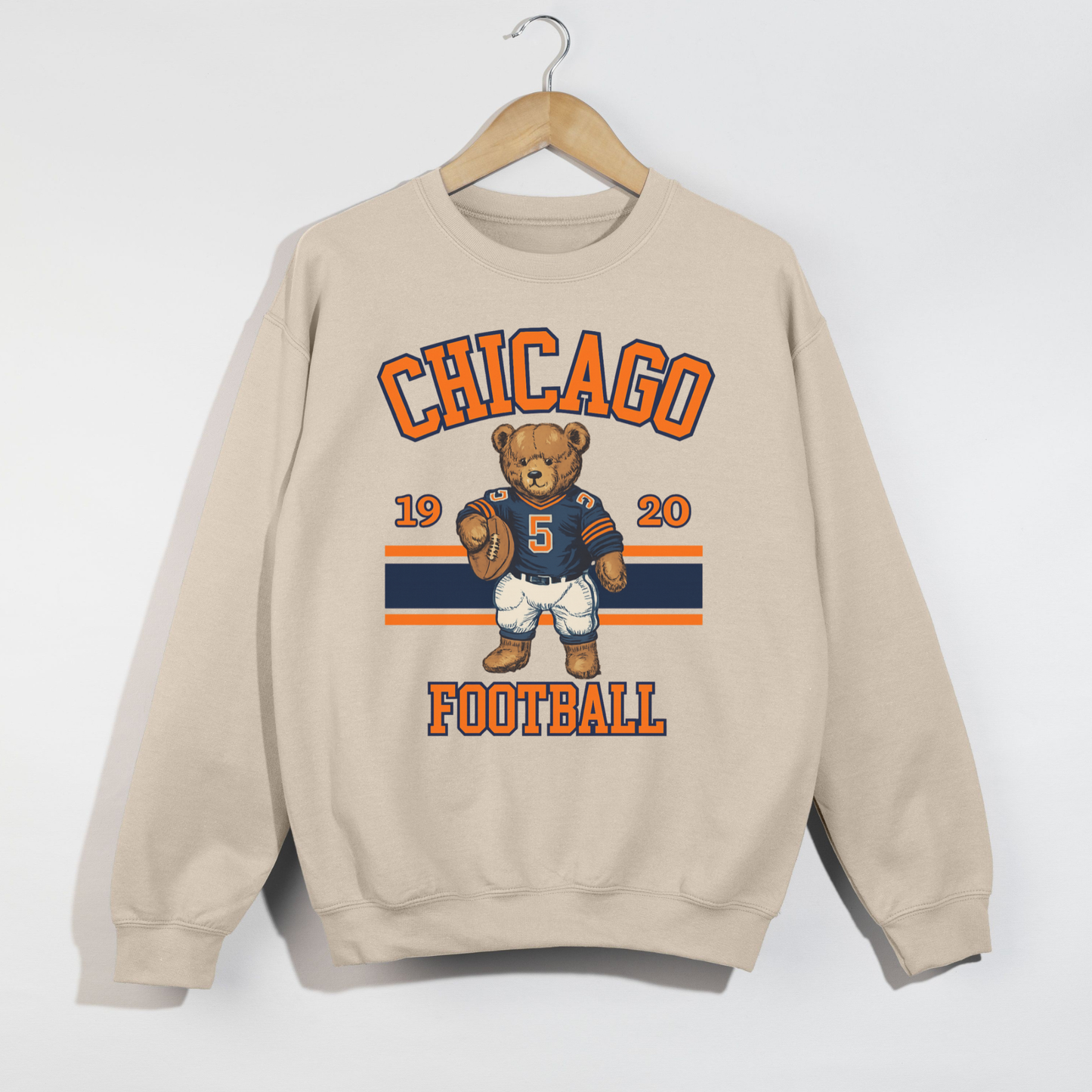 Beige sweatshirt with Chicago football design featuring a bear and numbers on a white background