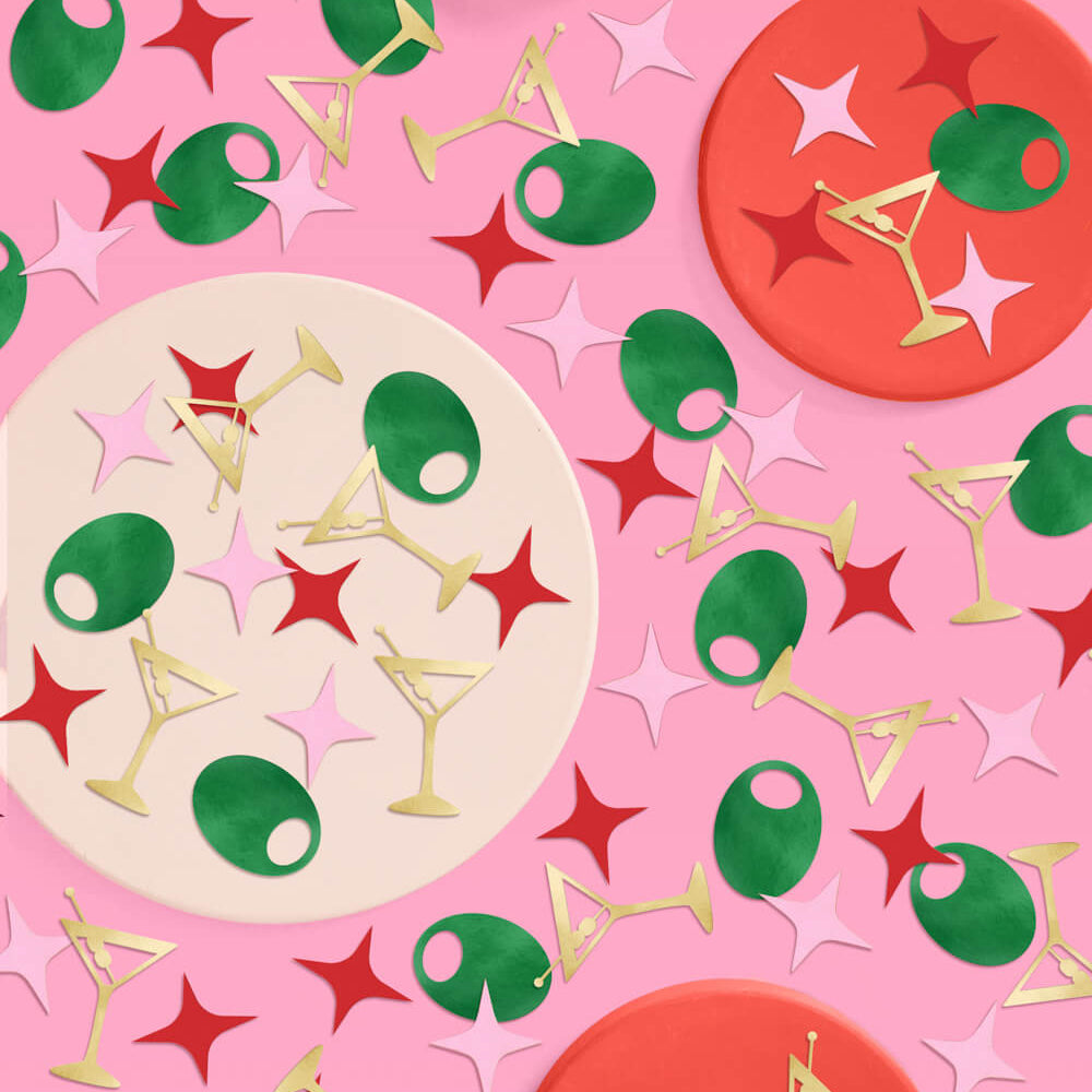 Gold martini glass and green olive foil confetti scattered on pink background for bachelorette party decor