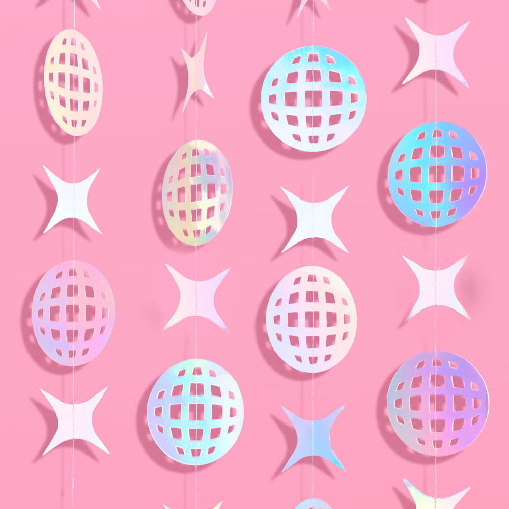 Decorative string with pastel-colored star and sphere shapes on a pink background