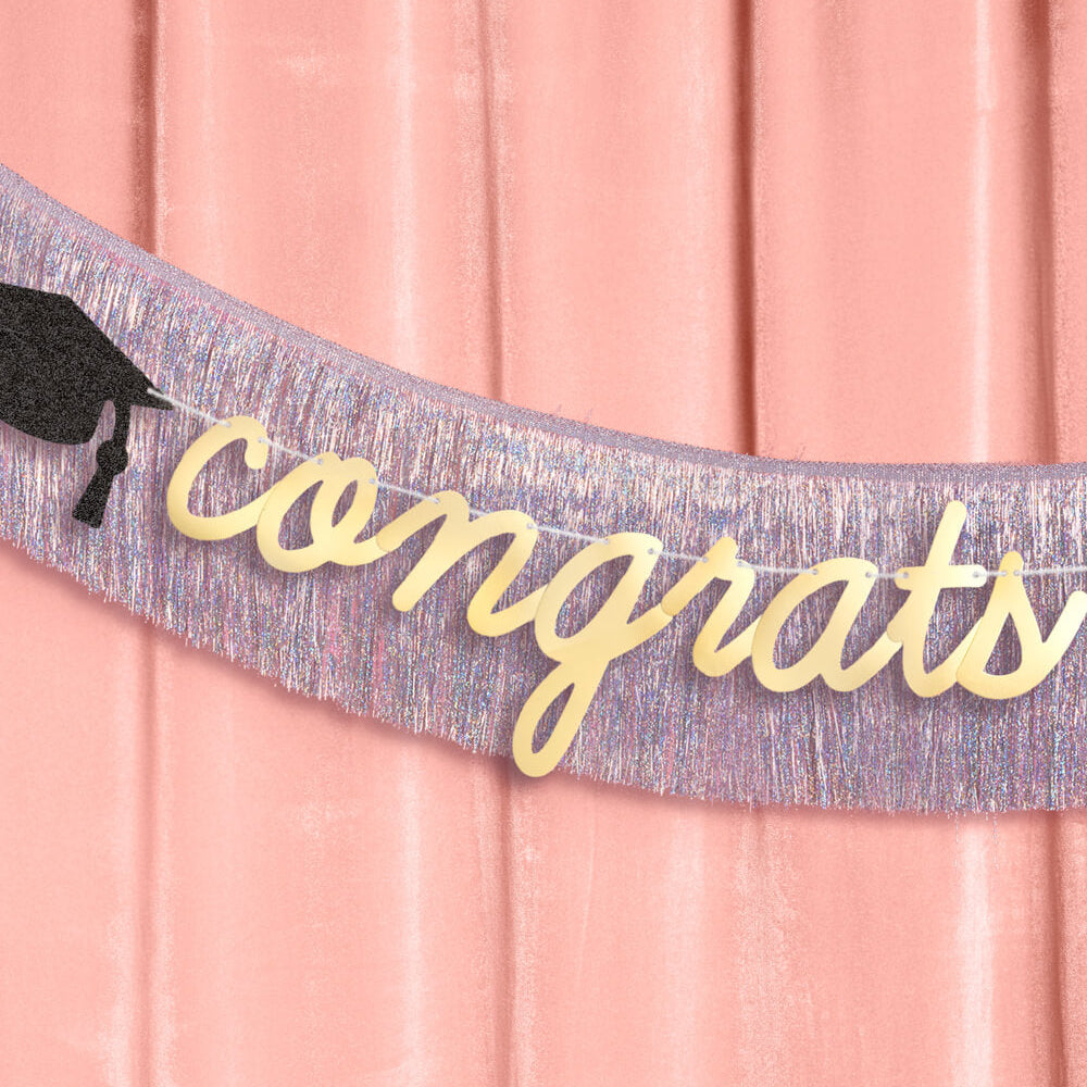 Graduation-themed sash with 'congrats' text on a pink background