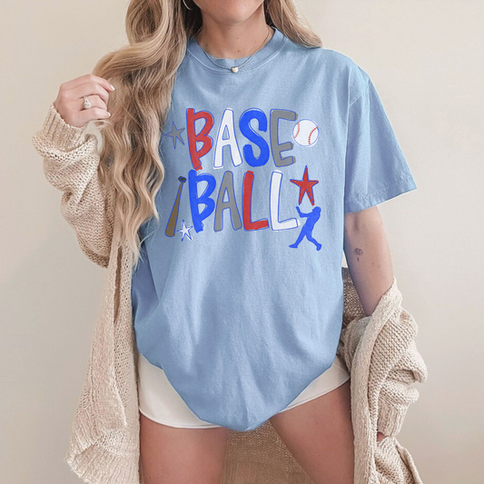 Woman wearing oversized blue retro baseball graphic t-shirt with red white and blue lettering styled with cozy cardigan.