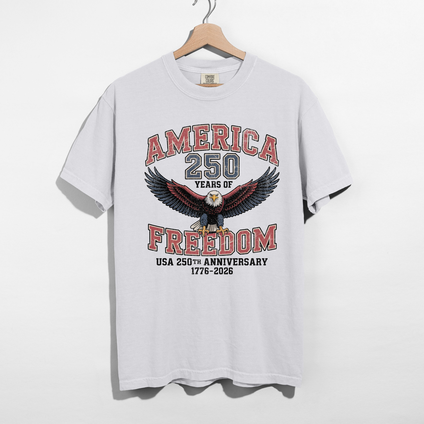 White America 250 Years of Freedom USA 250th Anniversary 1776–2026 graphic tee with vintage eagle design hanging on wooden hanger.