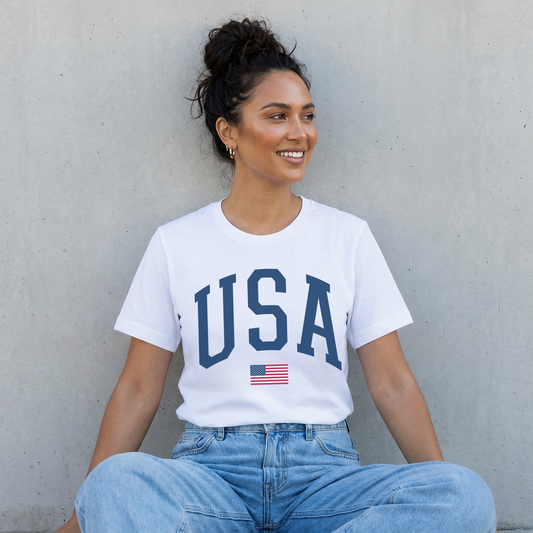 Woman wearing white USA varsity patriotic shirt with light wash jeans casual summer outfit