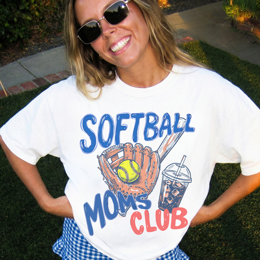 Woman wearing white Softball Moms Club graphic t-shirt with glove and softball design