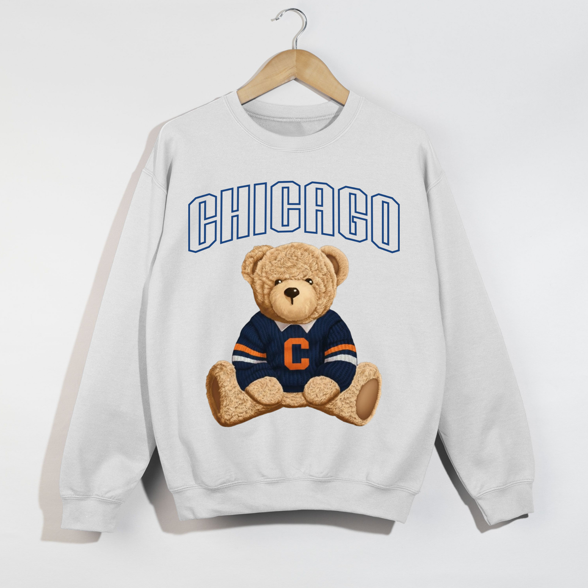 White Chicago teddy bear graphic sweatshirt on hanger with navy varsity lettering and vintage-inspired football design