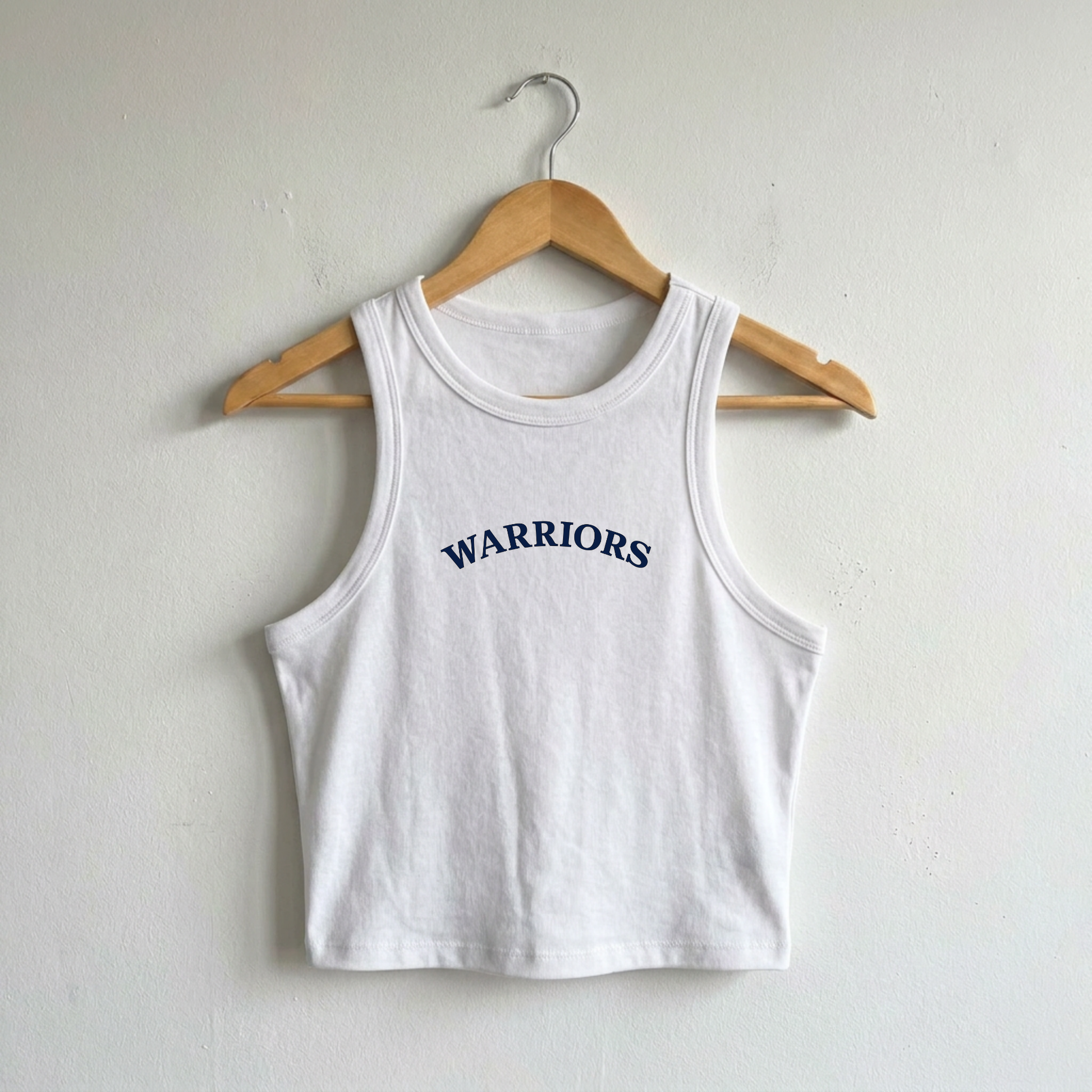 White ribbed crop tank featuring navy Sterling Warriors arched varsity graphic