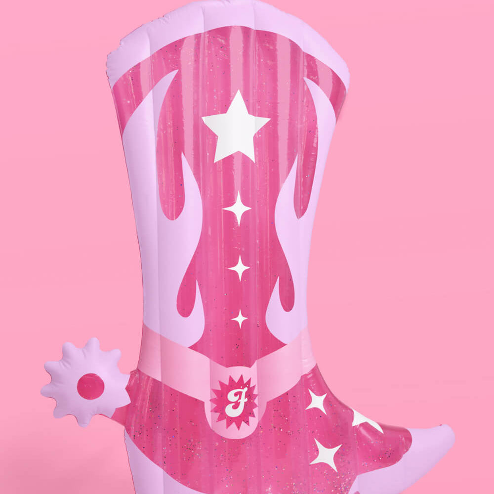 Pink cowboy boot with flames and stars on a pink background