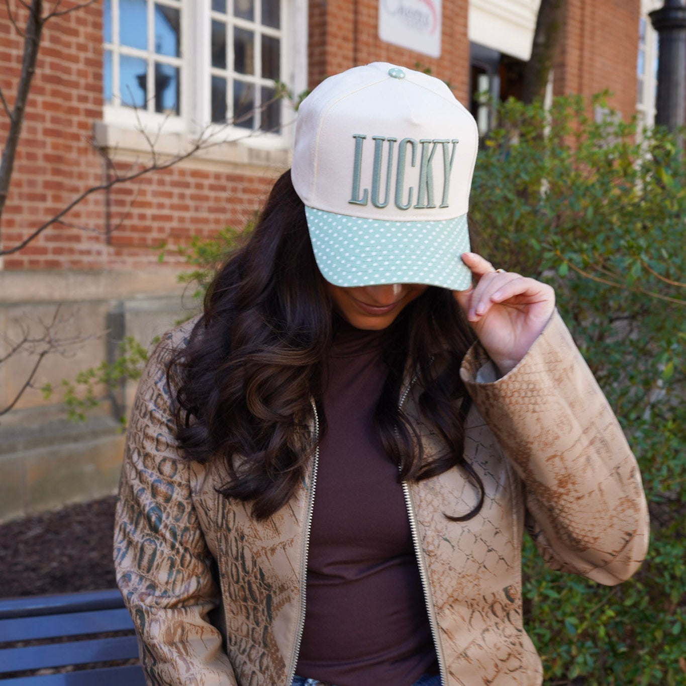 Person wearing a cap with 'LUCKY' text outdoors