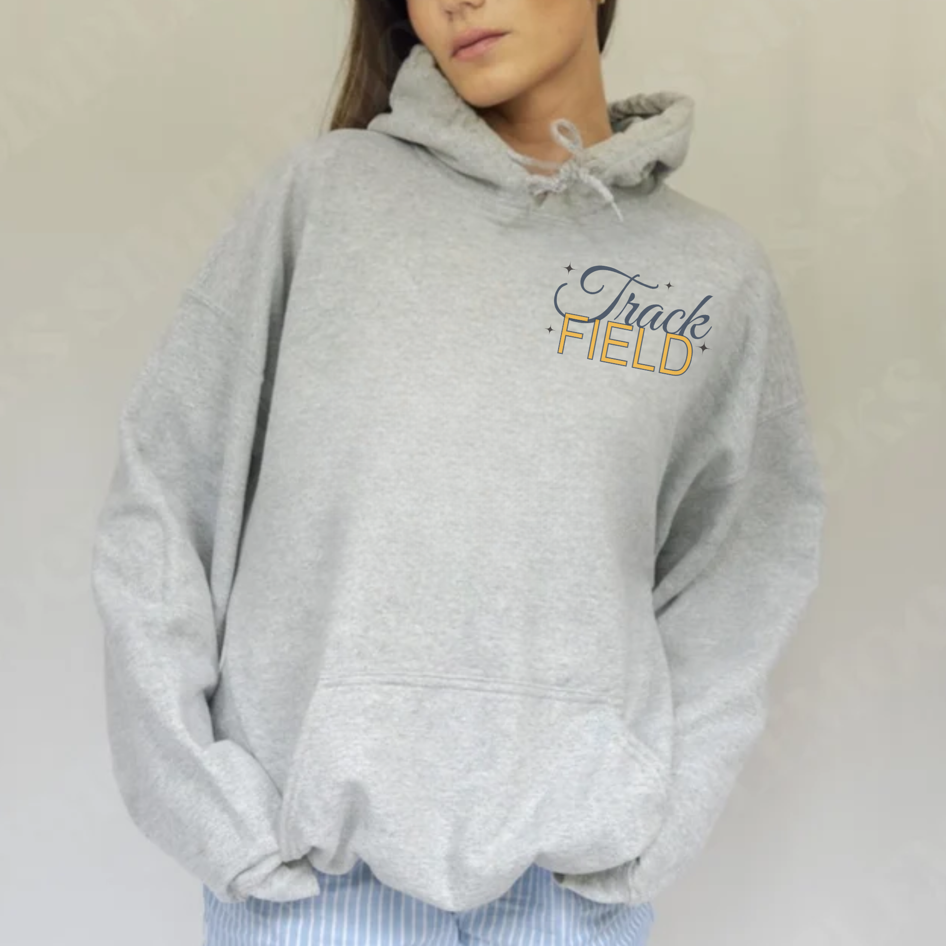 Ash grey Track Field Warriors hoodie front view with small chest graphic and drawstring hood