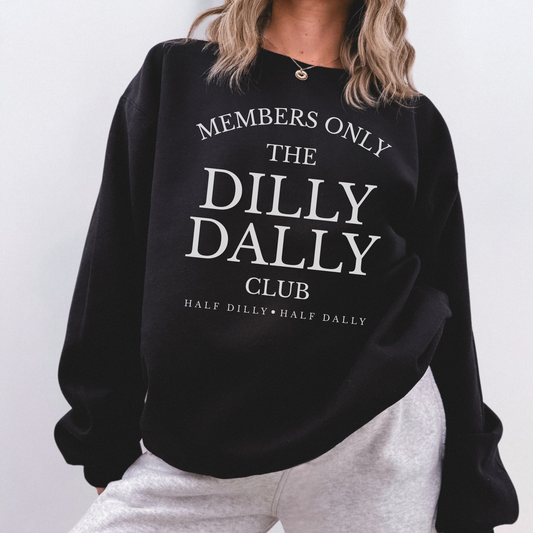 Model wearing a black “Dilly Dally Club” crewneck sweatshirt paired with grey sweatpants.