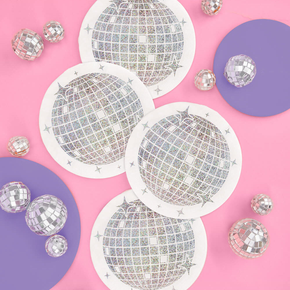 Discoball paper napkins on a pink and purple gradient background