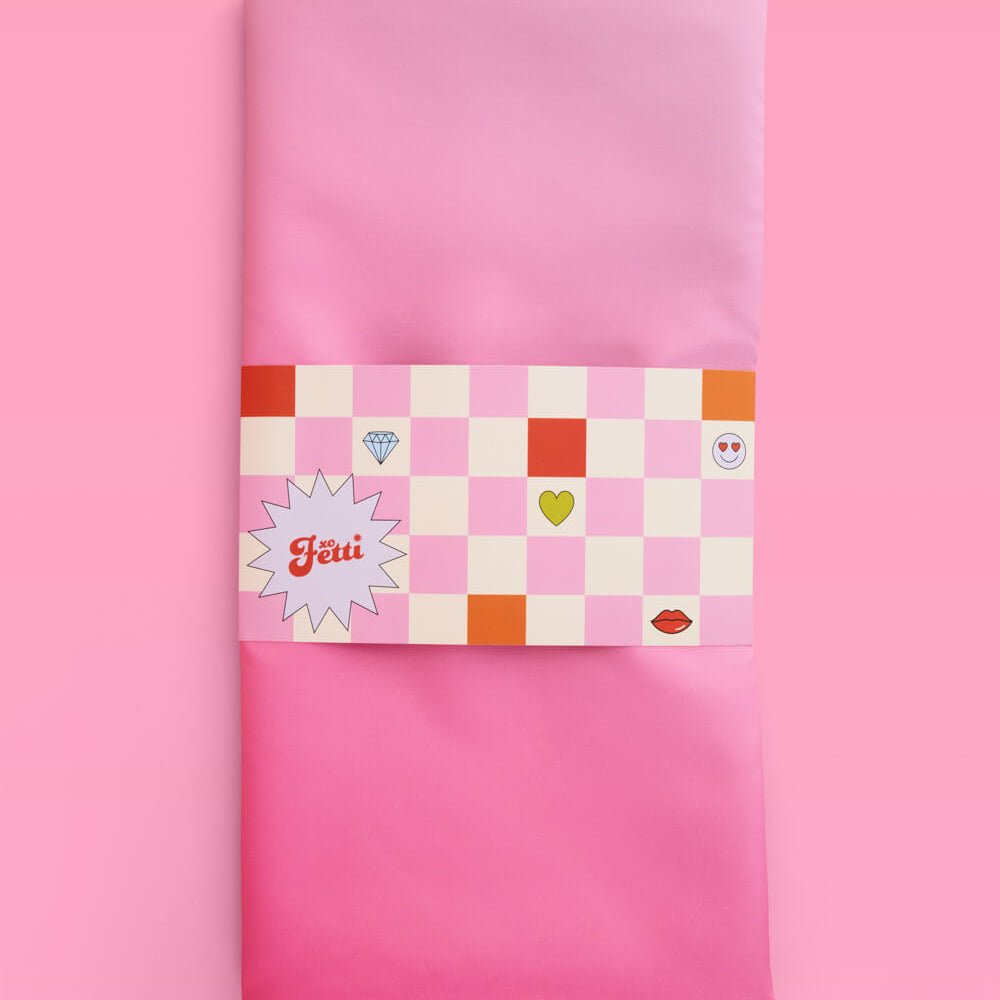 Pink fabric with a checkered label on a pink background