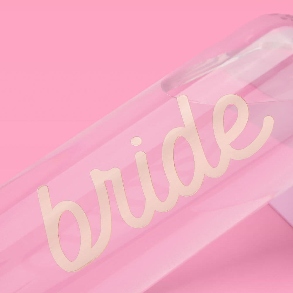 Clear water bottle with 'bride' text on a pink background