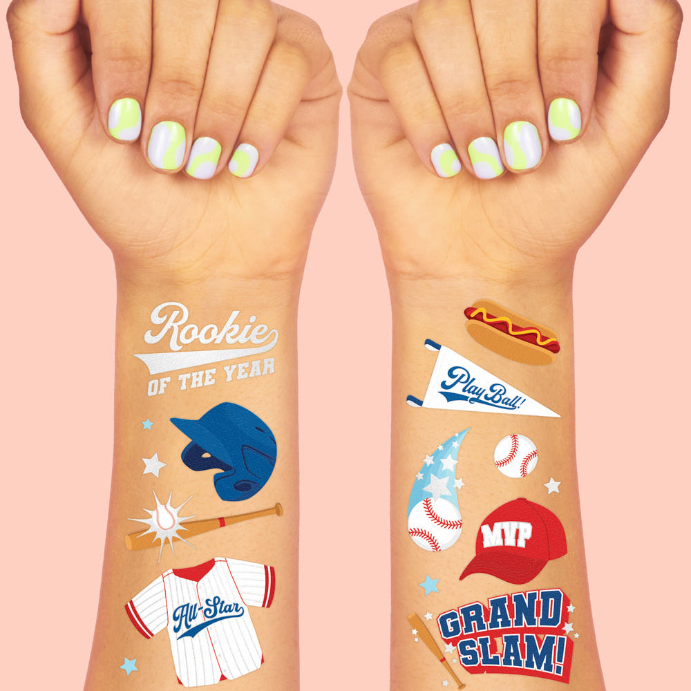 Two hands with colorful temporary tattoos on a pink background