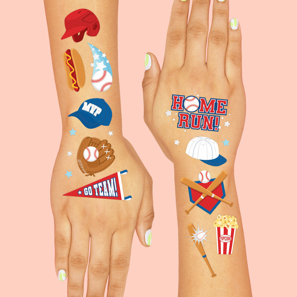Two hands with temporary tattoos on a pink background