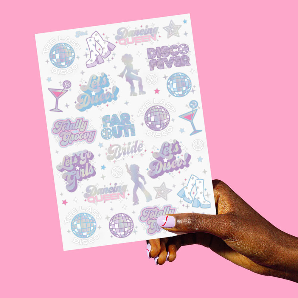Sheet of party-themed stickers held by a hand against a pink background