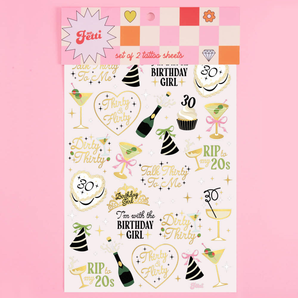 Sheet of birthday-themed temporary tattoos on a pink background