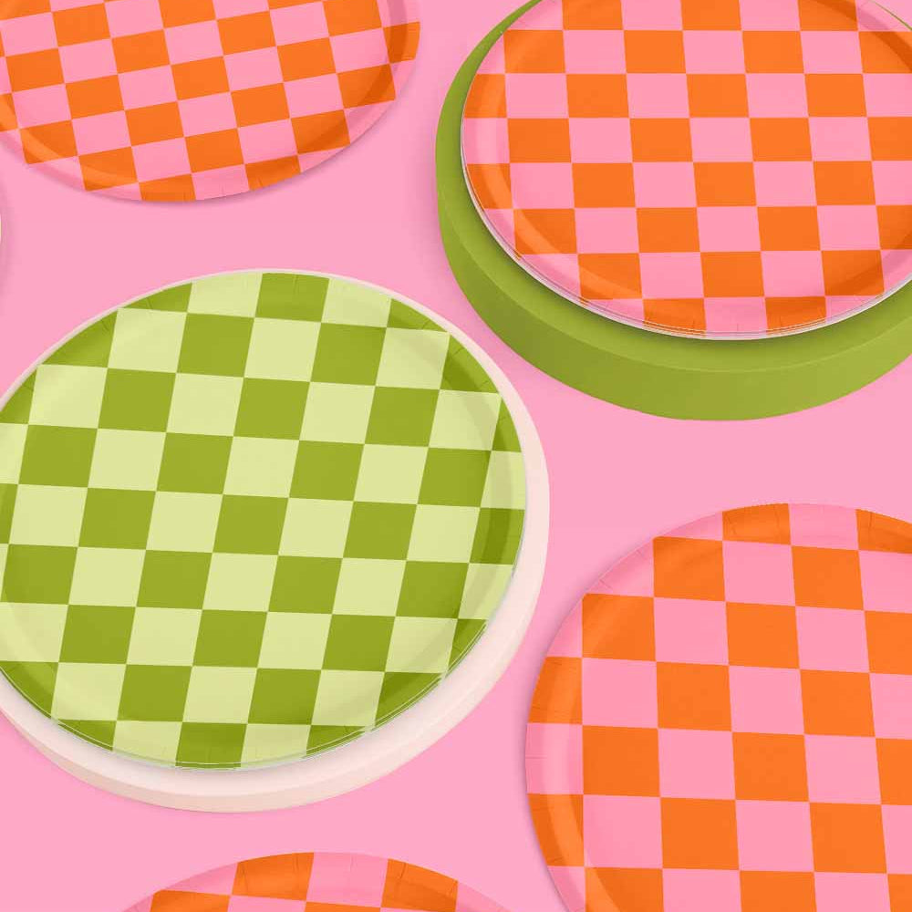 Checkered plates in green, orange, and pink on a pink background
