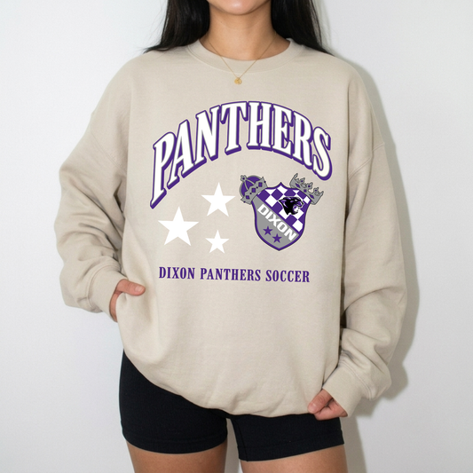Woman wearing Dixon Panthers Soccer sand crewneck sweatshirt with purple and white Panthers spirit wear graphic