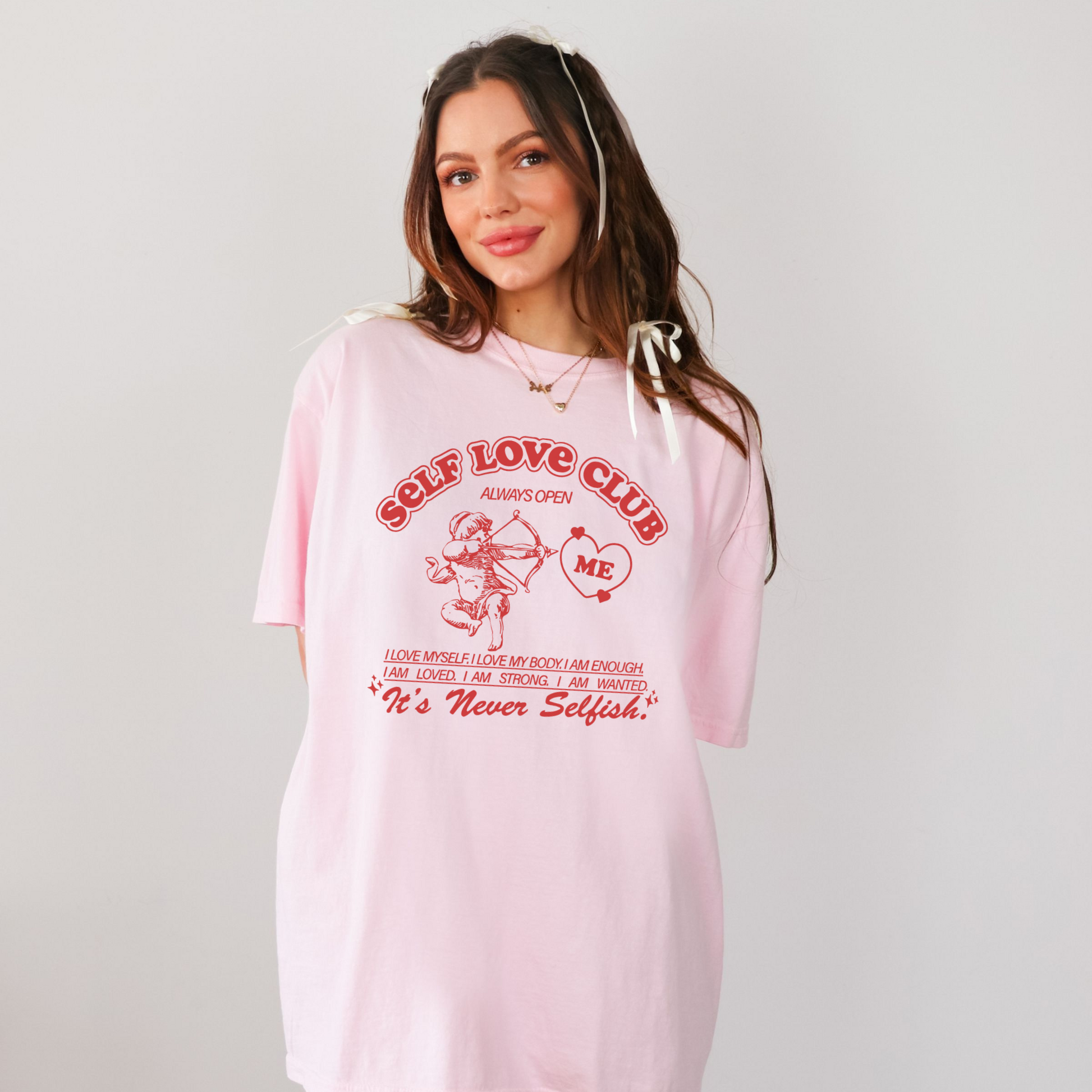 Front view of pink Self Love Club graphic t-shirt with cupid illustration