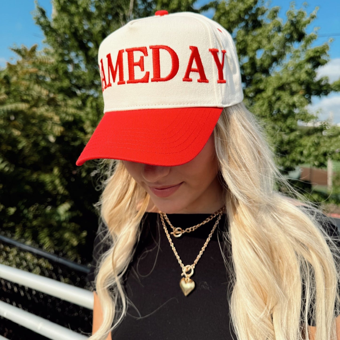 Person wearing a cap with 'Sameday' text outdoors