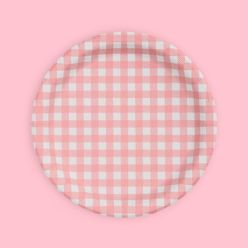 Round pink and white checkered plate on a pink background