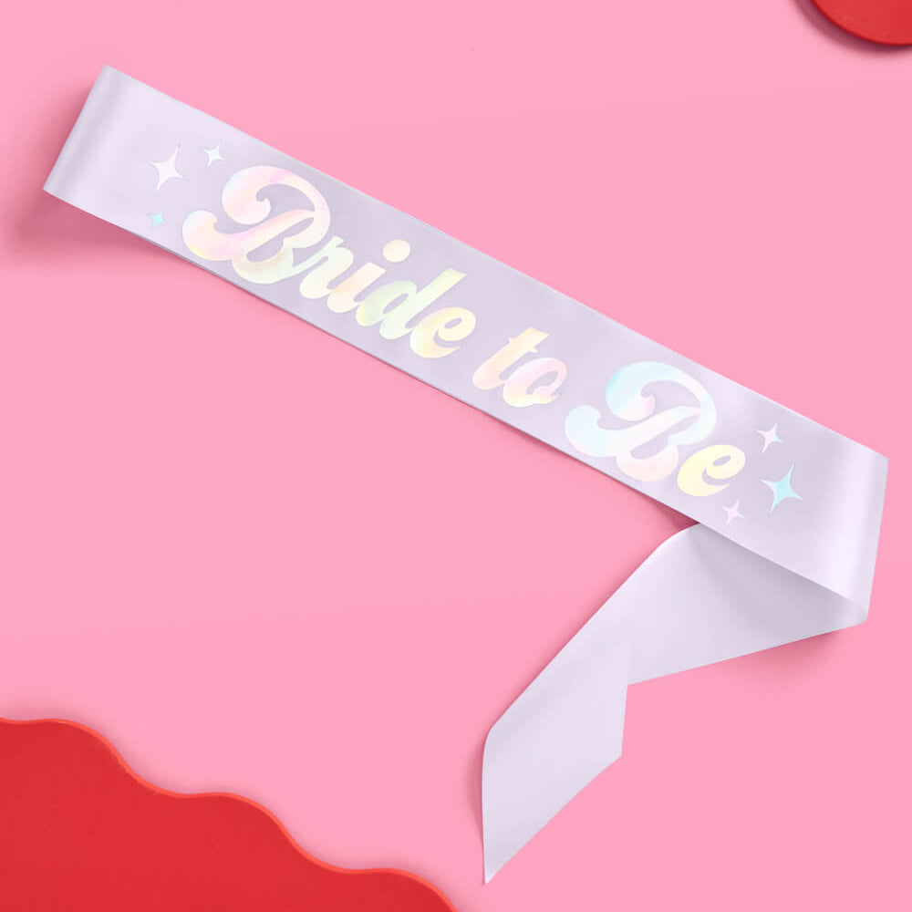 White sash with 'Bride to Be' text on a pink background