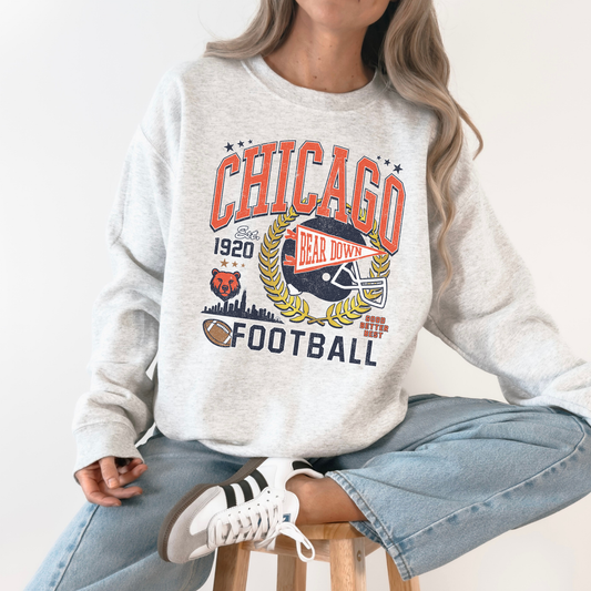 Person wearing a gray sweatshirt with 'Chicago Football' design on a white background