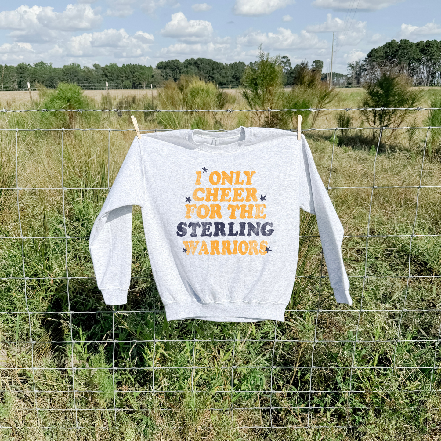 i only cheer for the sterling warriors sweatshirt gray crewneck displayed outdoors on fence rustic lifestyle product image
