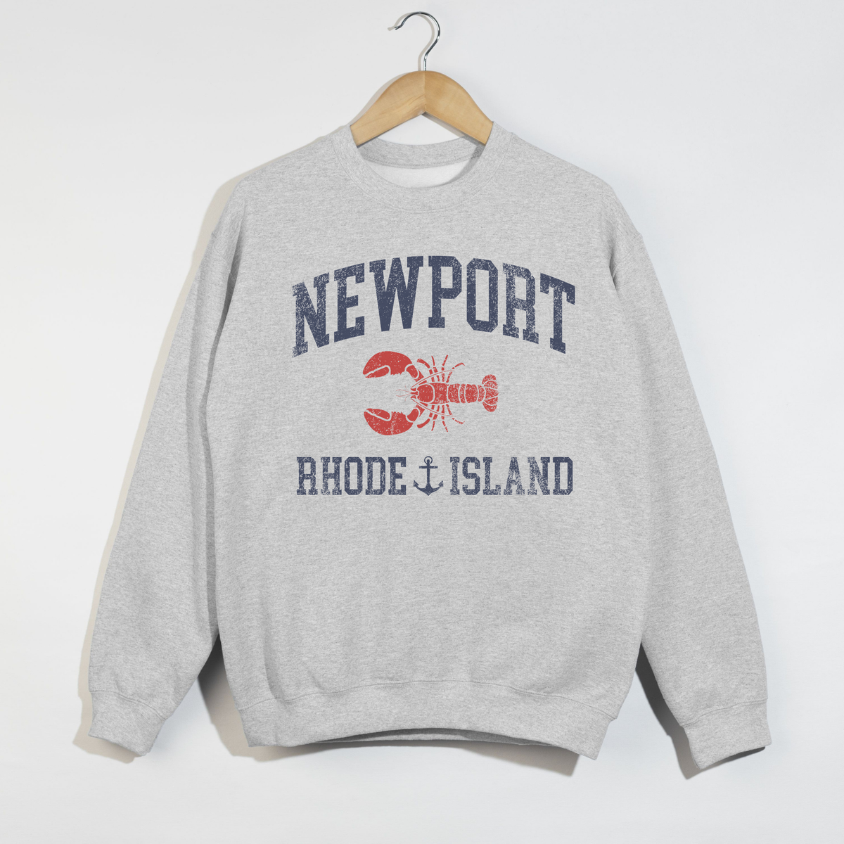 Gray Newport Rhode Island sweatshirt with lobster graphic and nautical text hanging on hanger