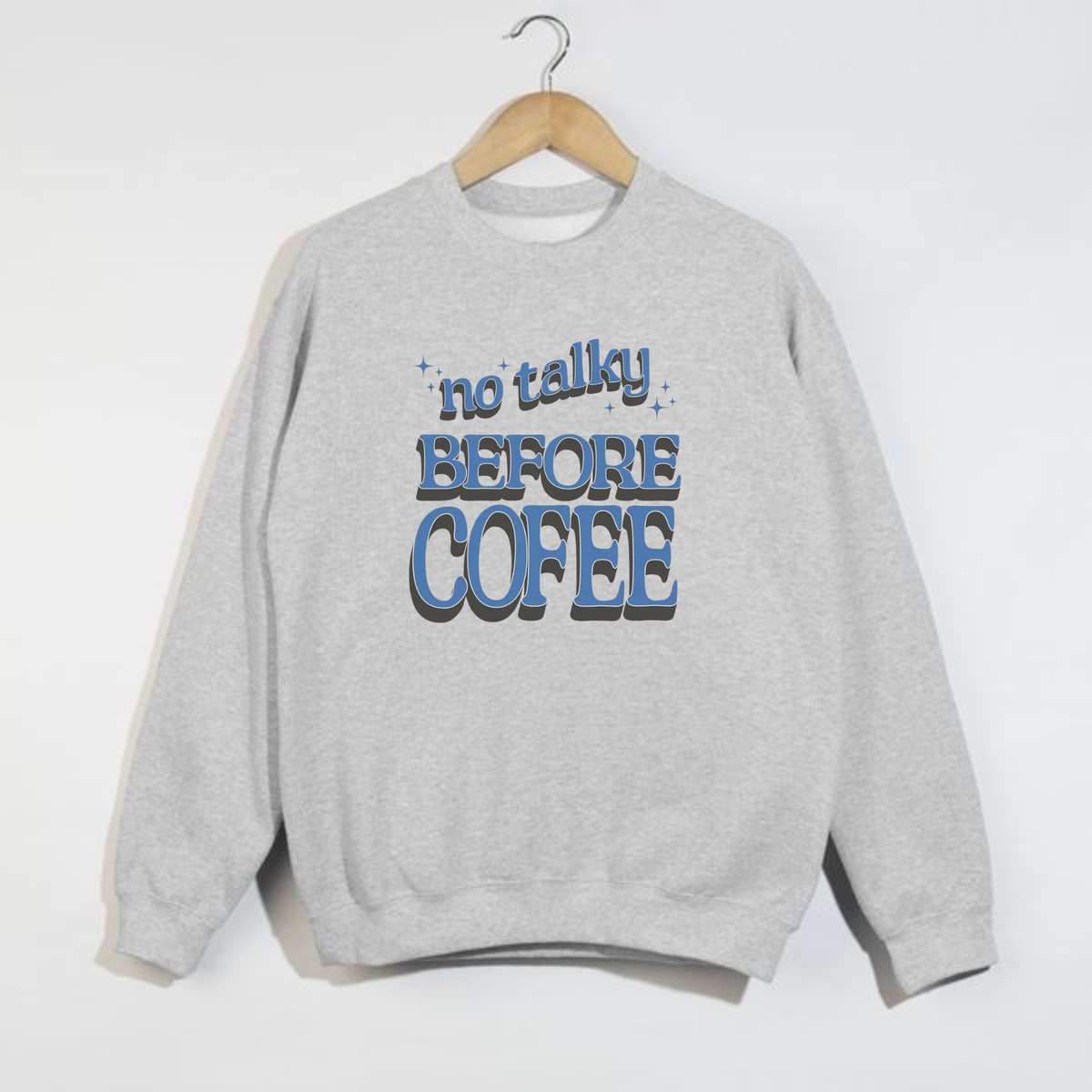Ash grey sweatshirt with blue vintage-style ‘No Talky Before Coffee’ text graphic