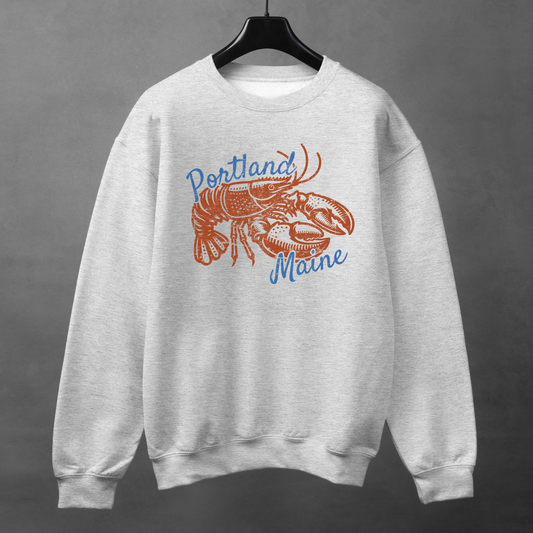Portland Maine lobster graphic sweatshirt in ash grey displayed on black hanger against neutral background.