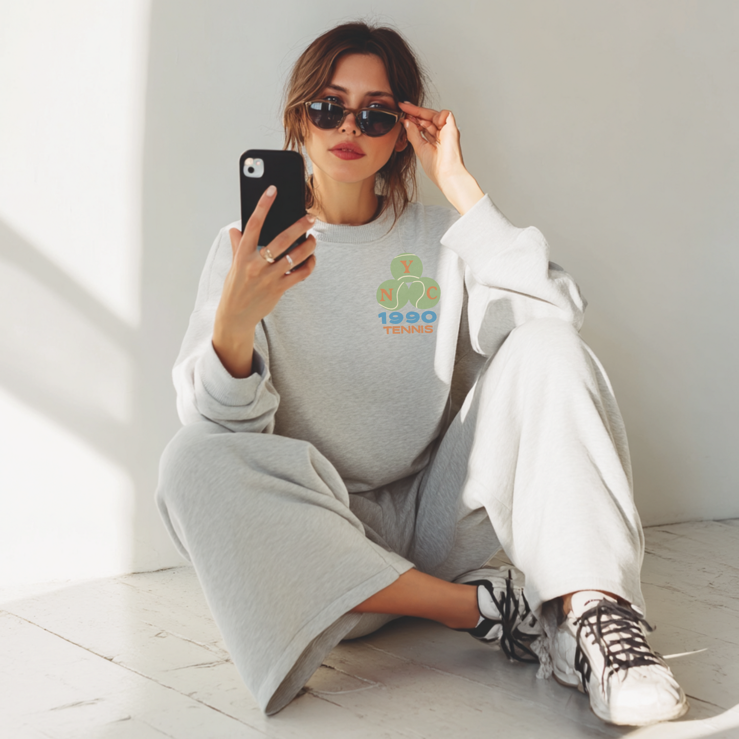 Ash grey NYC tennis sweatshirt styled casually with vintage tennis design