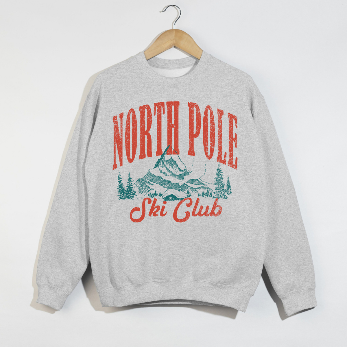 North Pole Ski Club ash grey sweatshirt featuring vintage ski club mountain graphic in red-orange and teal