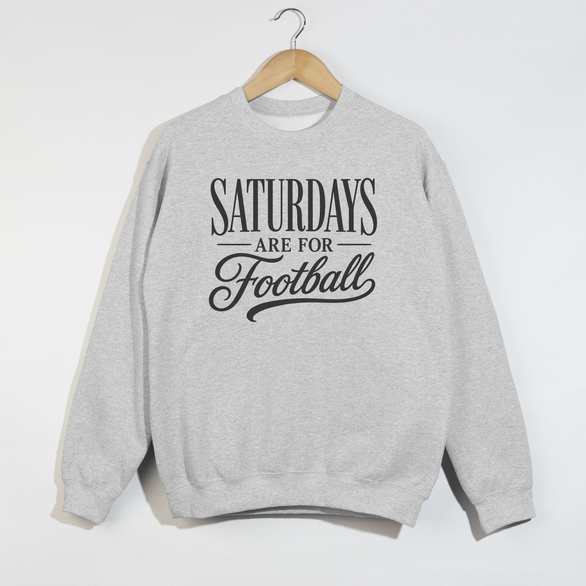 Ash gray football graphic sweatshirt with "Saturdays Are For Football" vintage lettering displayed on a relaxed unisex crewneck.