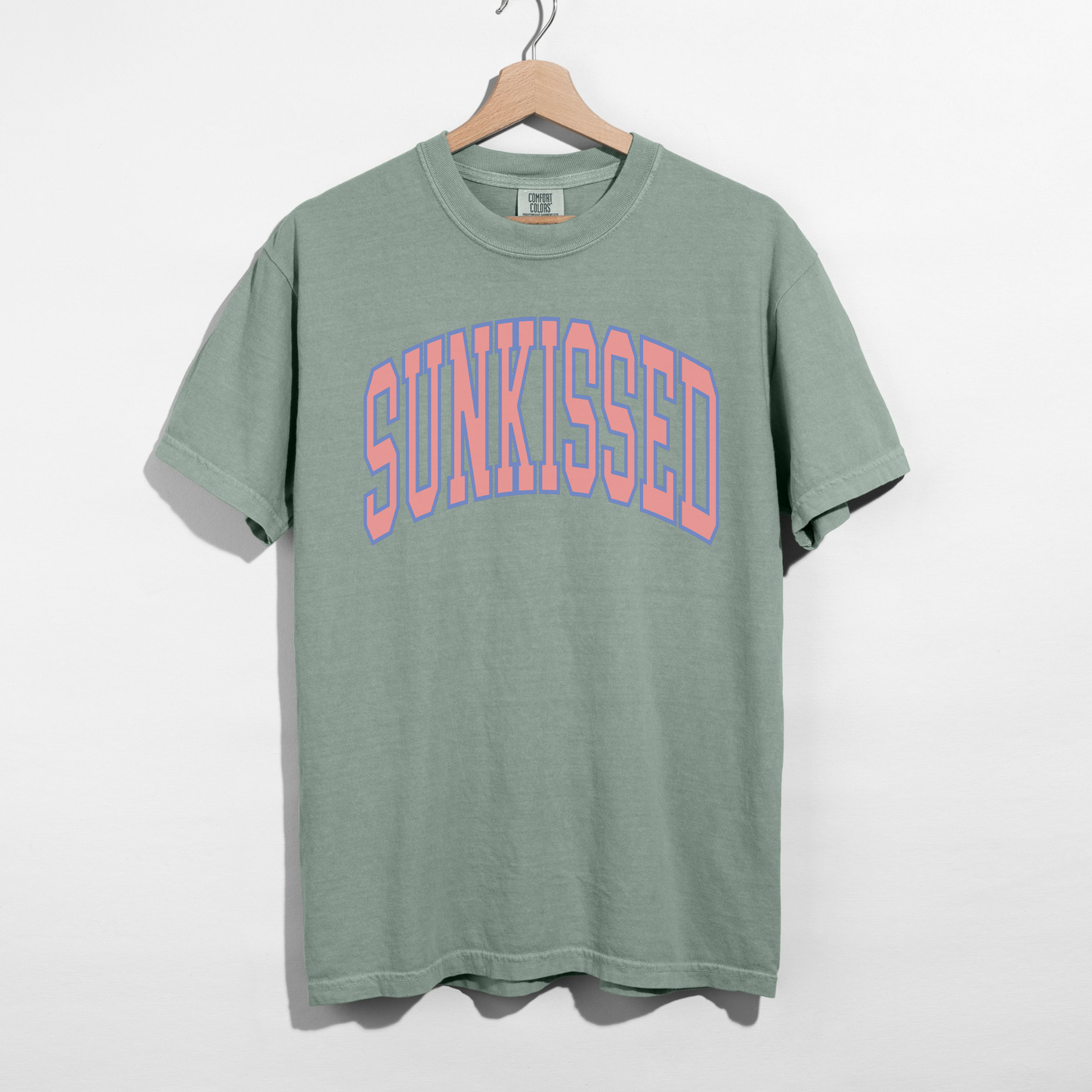 Bay green SUNKISSED graphic t-shirt with pastel arch text, relaxed fit unisex tee