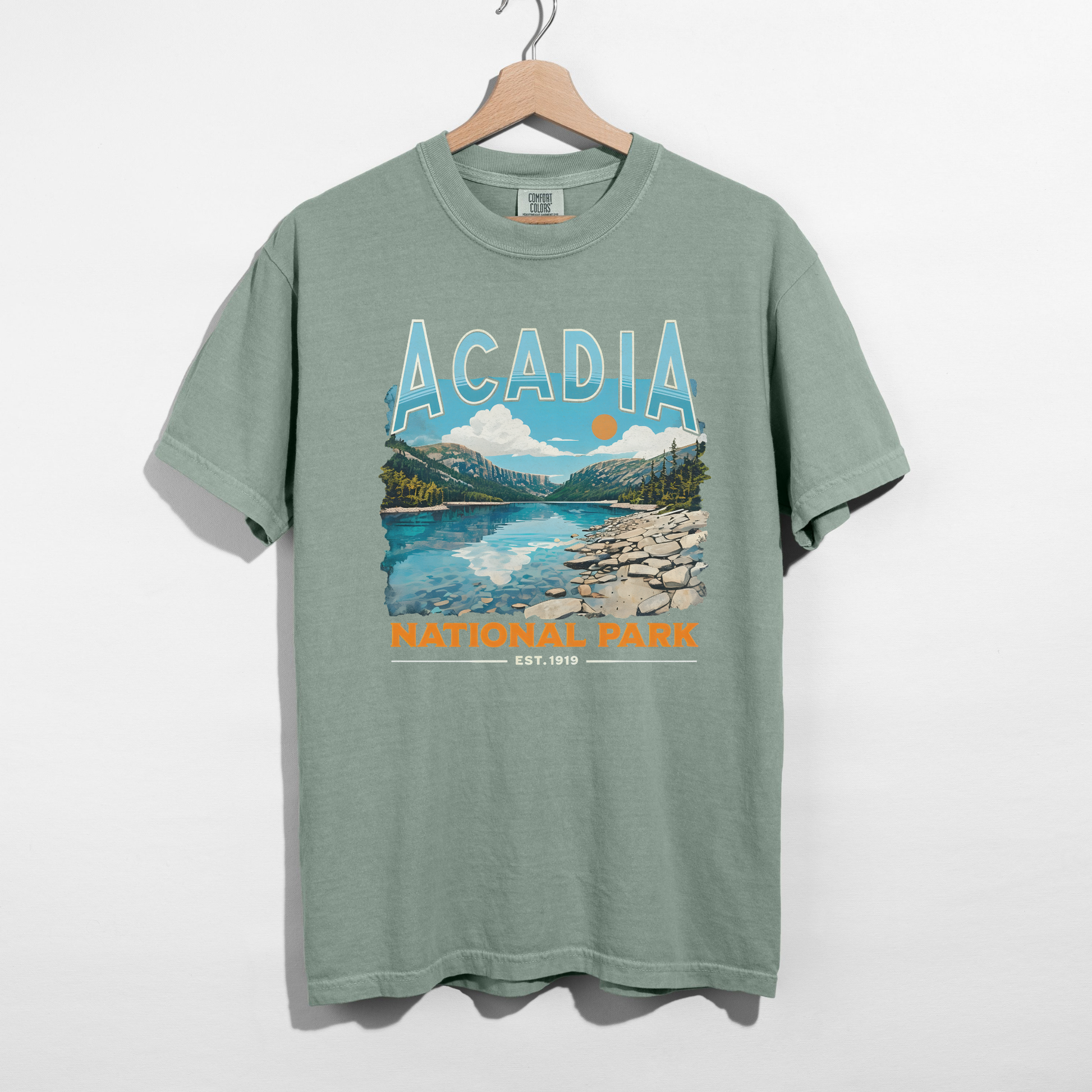 Bay green Acadia National Park scenic graphic t-shirt with mountain lake design and National Park est. 1919 detail.